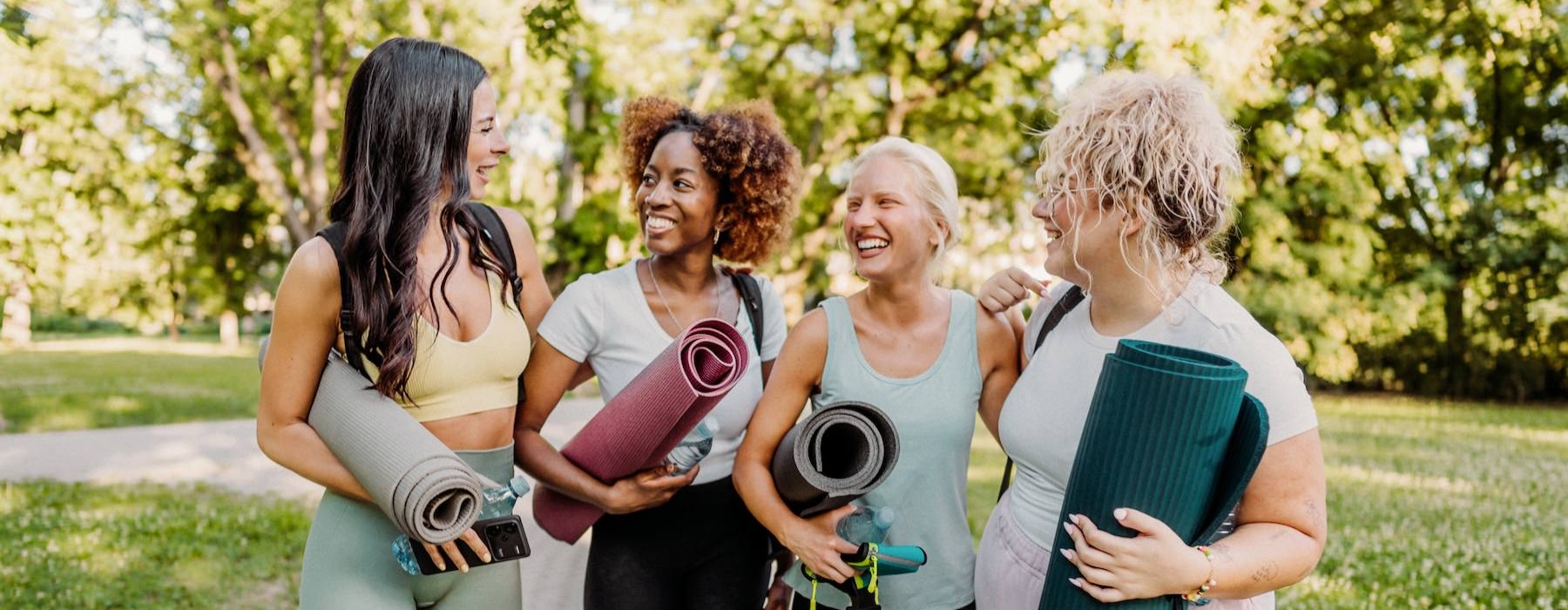 a group of women walking on a sidewalk