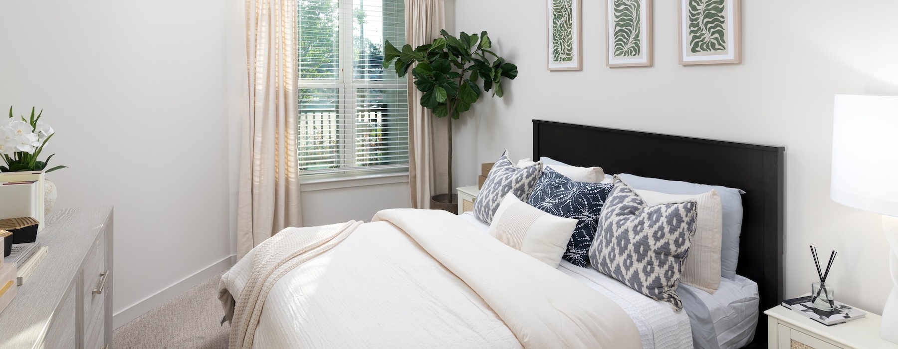 a bedroom with a bed and a plant