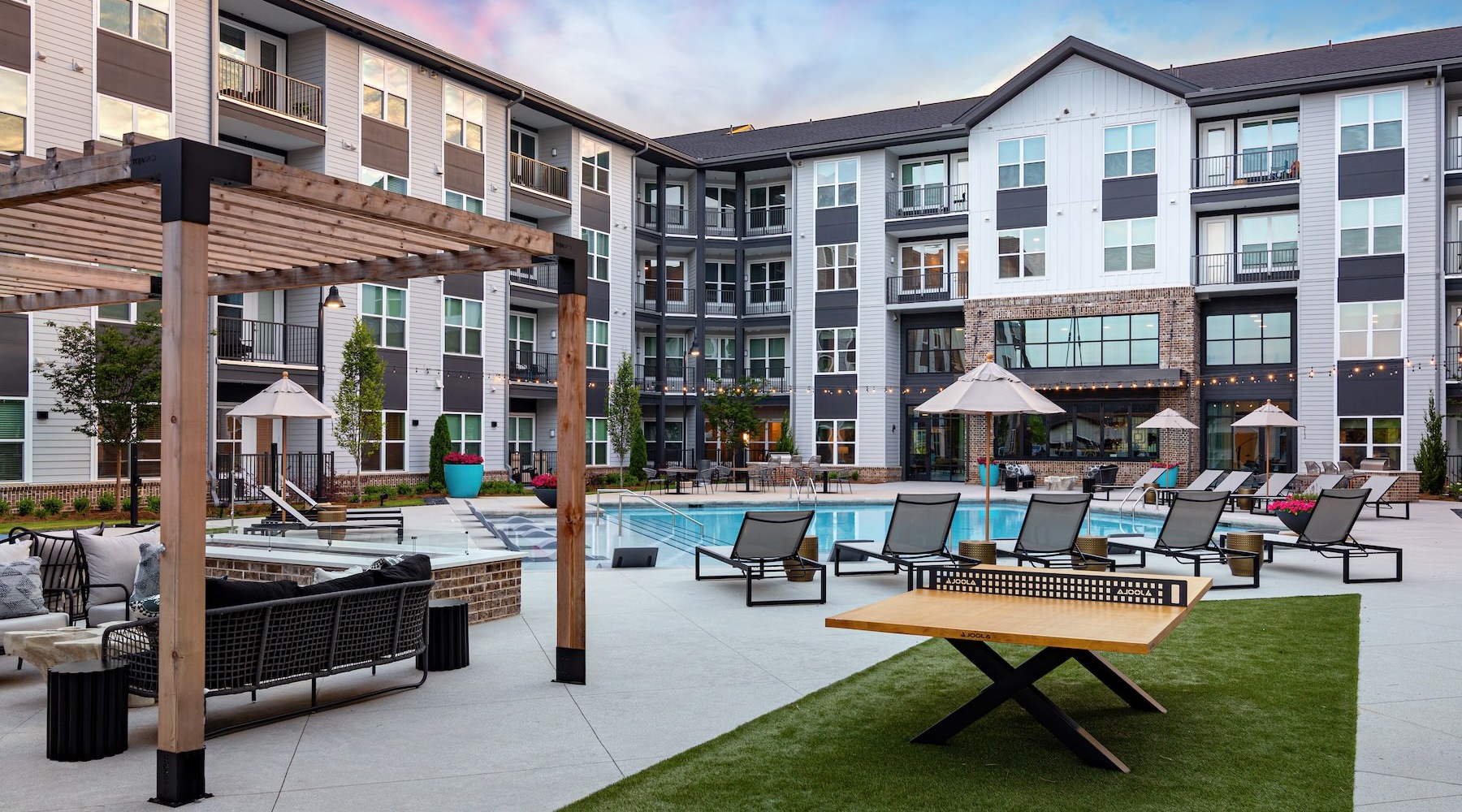 a courtyard with a pool and chairs